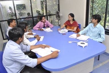 A Gondwana project team reviewing documents together around a meeting table