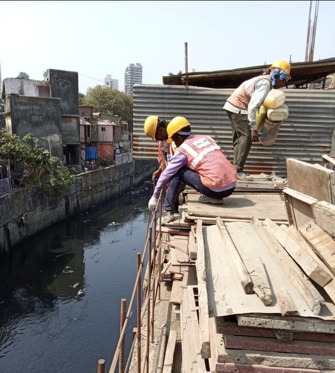 Gondwana crew intercepting sewage flow over the Poisar channel during construction of the decentralised treatment plants