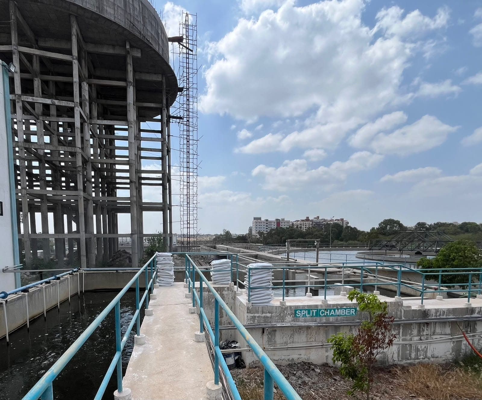 Split-chamber flow-distribution structure feeding the circular treatment basins at the PCMC 100 MLD water treatment plant