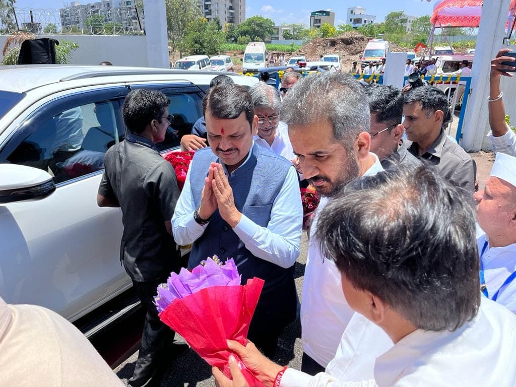 A senior state dignitary received with a bouquet at the inauguration of the PCMC 100 MLD water treatment plant, with officials gathered at the plant gate