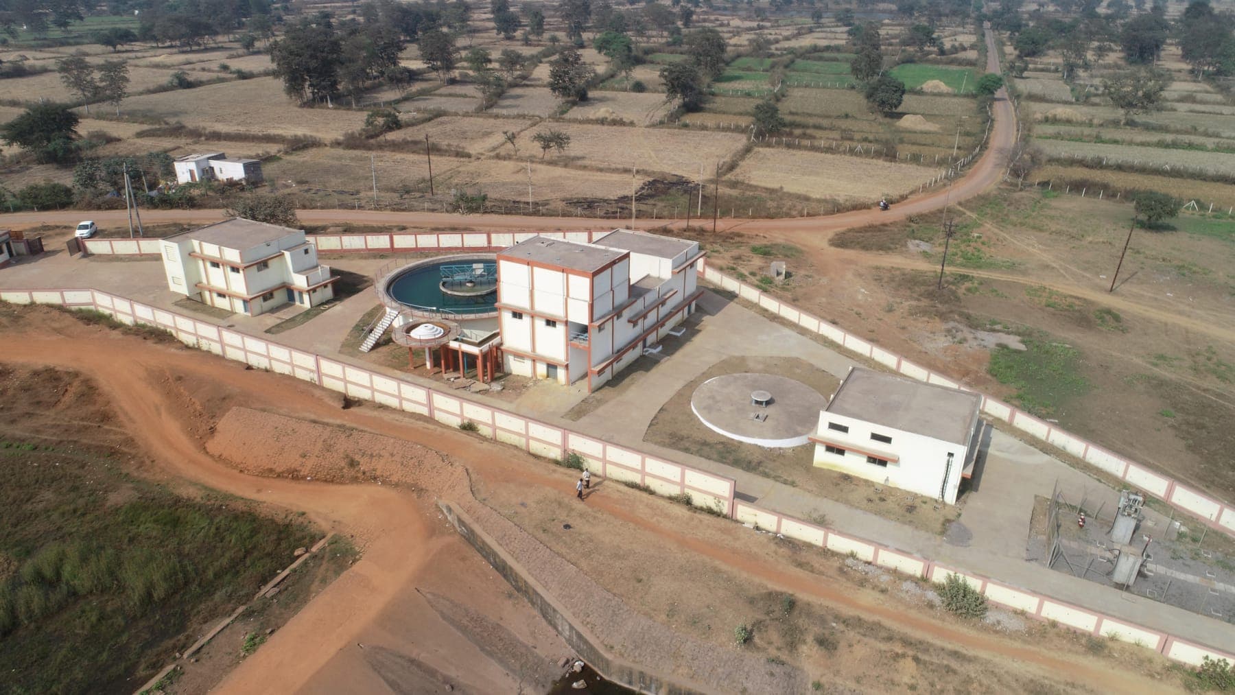 Wide aerial of the SAIL Bhilai tertiary plant compound with circular treatment tank and control buildings within the boundary wall
